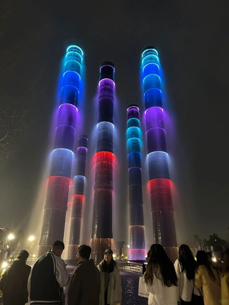 Colorful illuminated water towers at a night time fountain show in Chengdu
