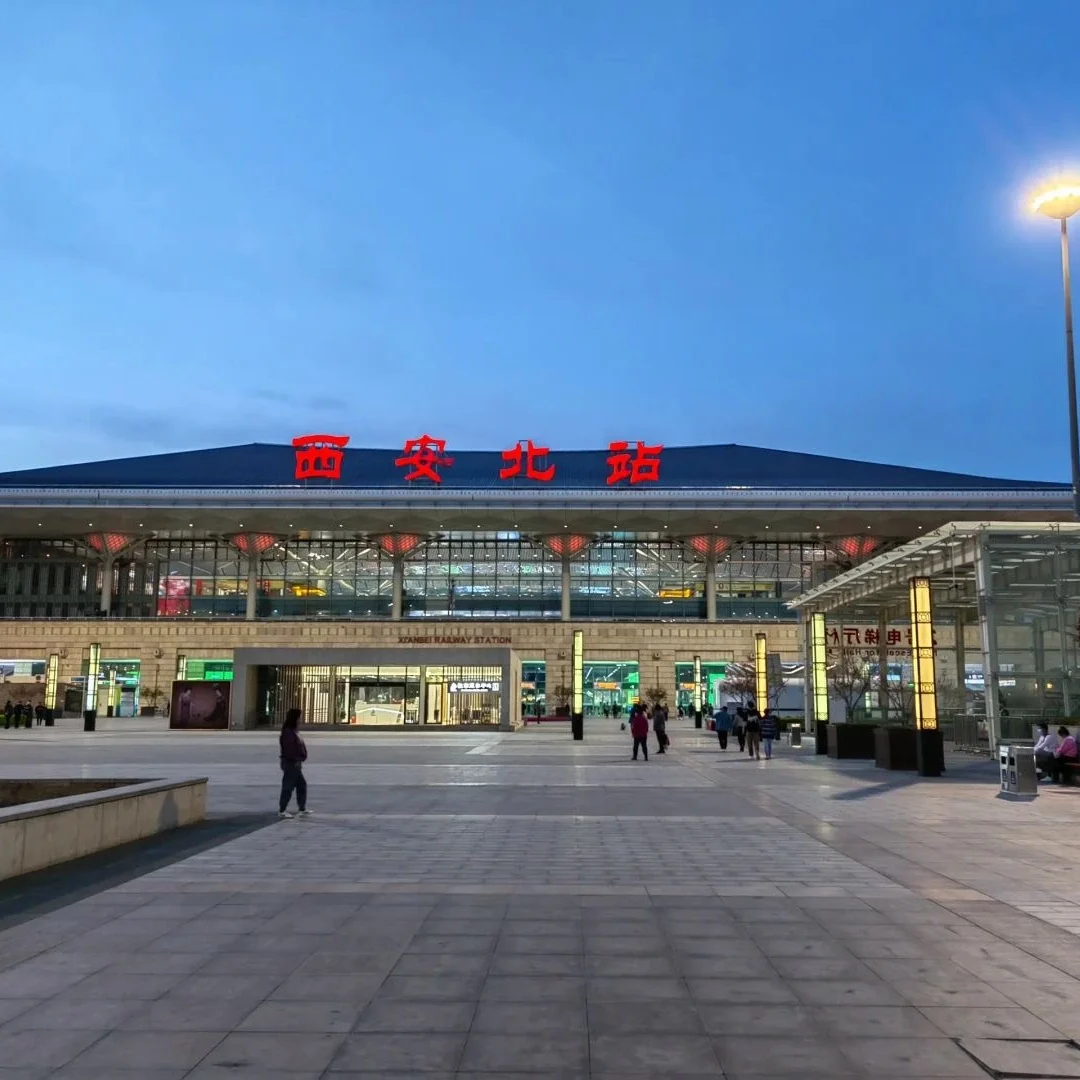Evening shot of Xianbei Railway Station illuminated with lights and a few people walking around the entrance - Xi’an: Basic Info, History, Climate & So on 2026 - The China Journey - Xi’an: Basic Info, History, Climate & So on 2026 - The China Journey Evening shot of Xianbei Railway Station illuminated with lights and a few people walking around the entrance - Xi’an: Basic Info, History, Climate & So on 2026 - The China Journey - Xi’an: Basic Info, History, Climate & So on 2026 - The China Journey