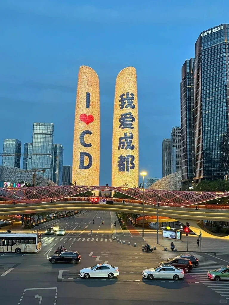 Night view of the illuminated I Love Chengdu towers in the city center with modern skyscrapers in the background