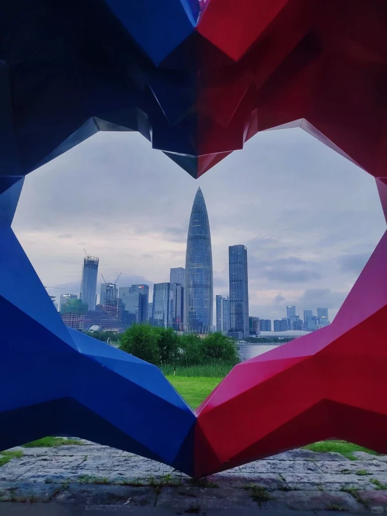 Shenzhen cityscape viewed through a heart shaped sculpture in the park