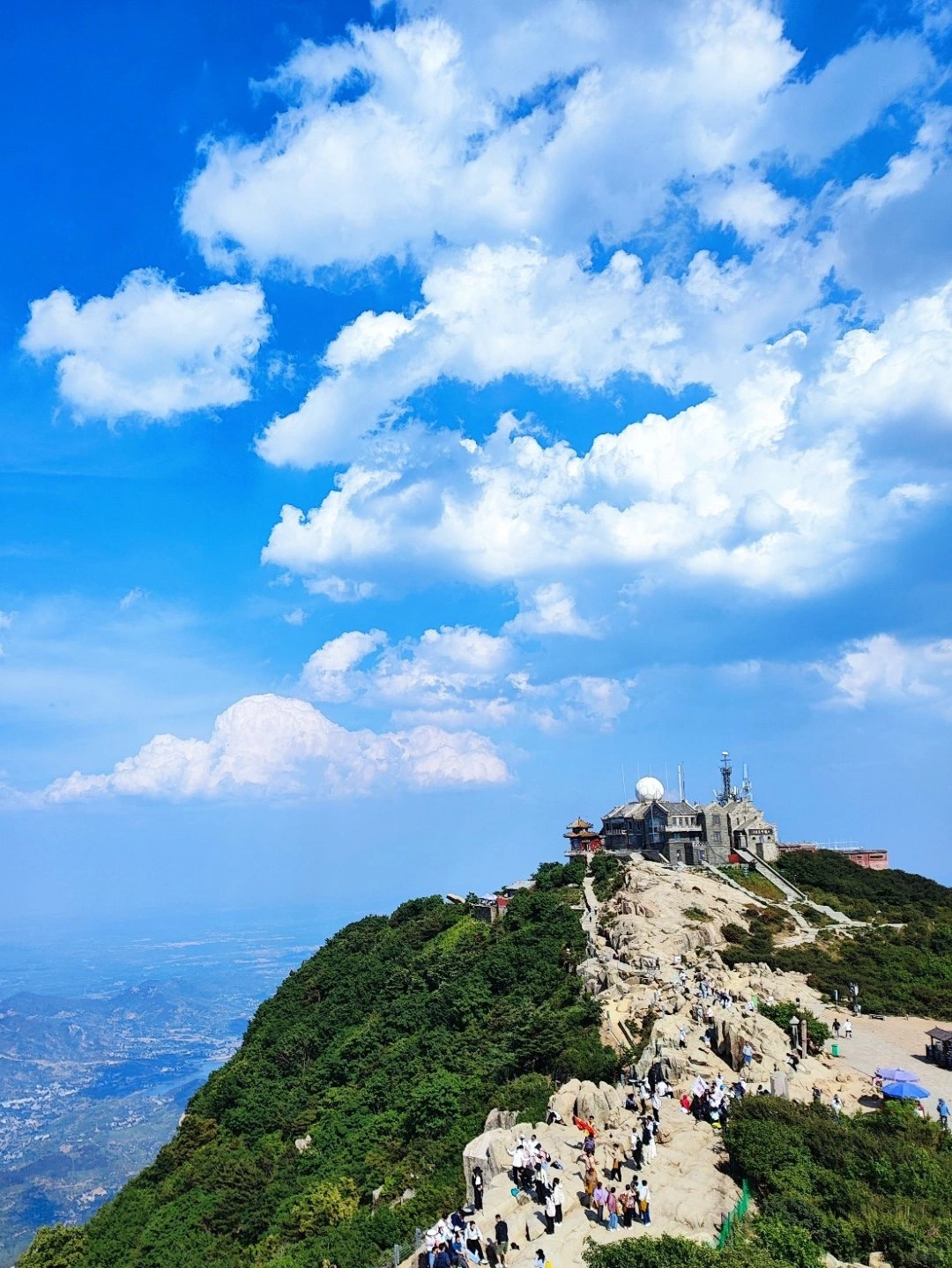 Mount Tai peak with tourists enjoying the view of the surrounding landscape