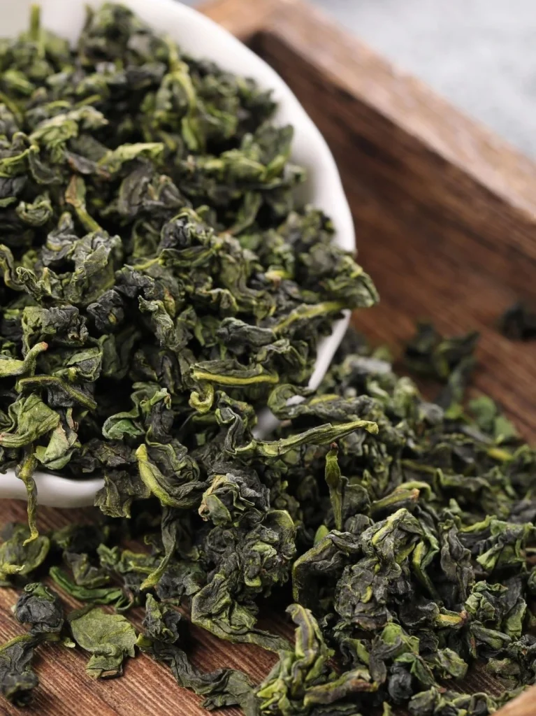 Close up of Dried Tieguanyin Tea Leaves in a White Bowl