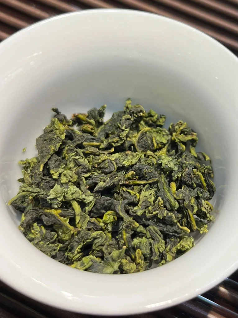Fresh Tieguanyin Tea Leaves in a Ceramic Cup