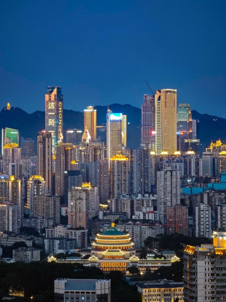 Night view of Chongqing city with brightly lit skyscrapers and traditional Chinese architecture
