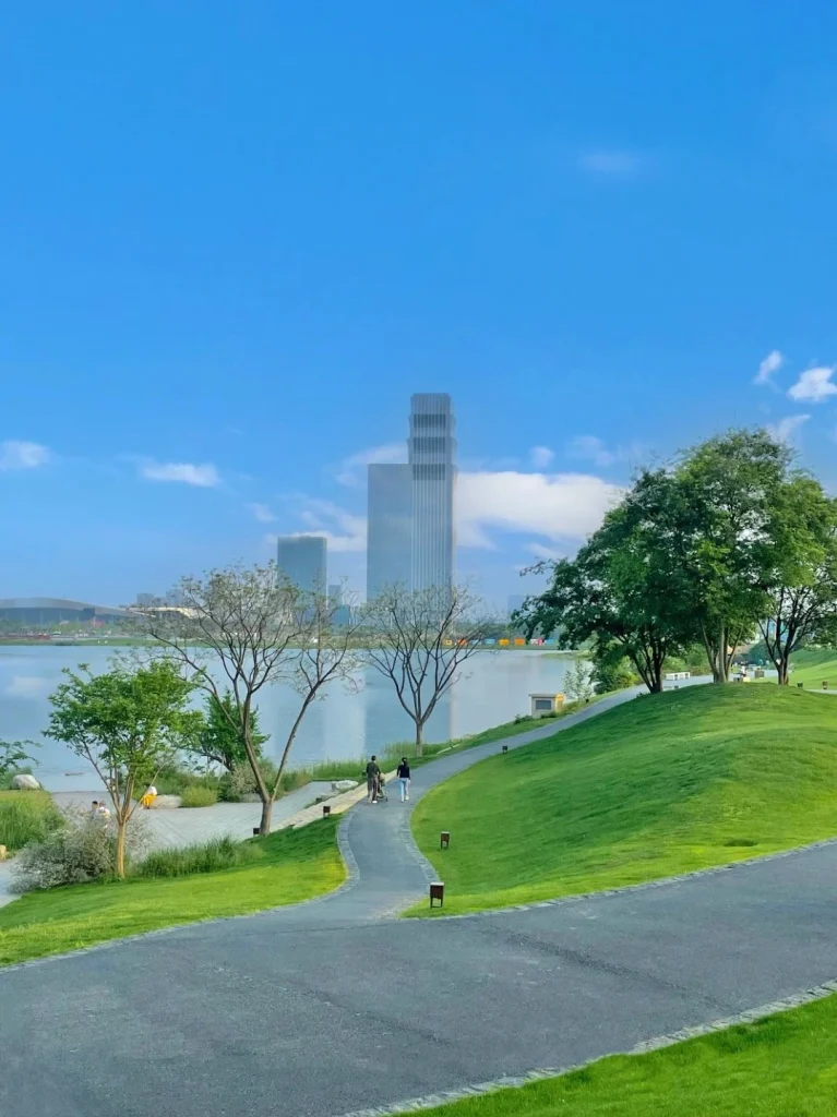 Beautiful green park with a serene lake and cityscape view in Chengdu China