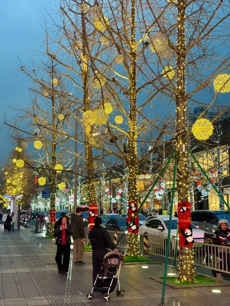 Bustling street in Chengdu adorned with twinkling lights and panda themed decorations highlighting the citys festive spirit