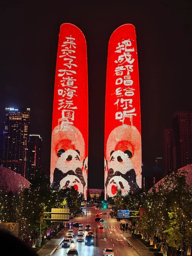 Chengdu Twin Towers lit up with panda themed red light projection at night