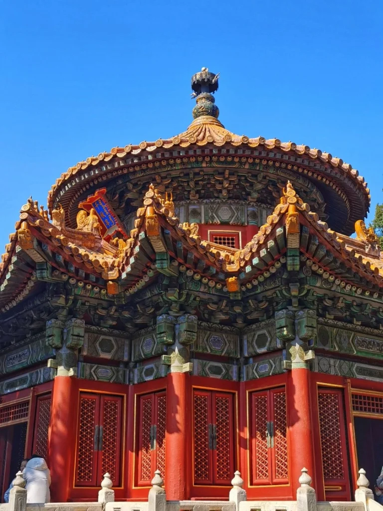 Forbidden City Pavilion Beijing A beautifully decorated circular pavilion in the Forbidden City featuring ornate wood carvings and glazed tiles