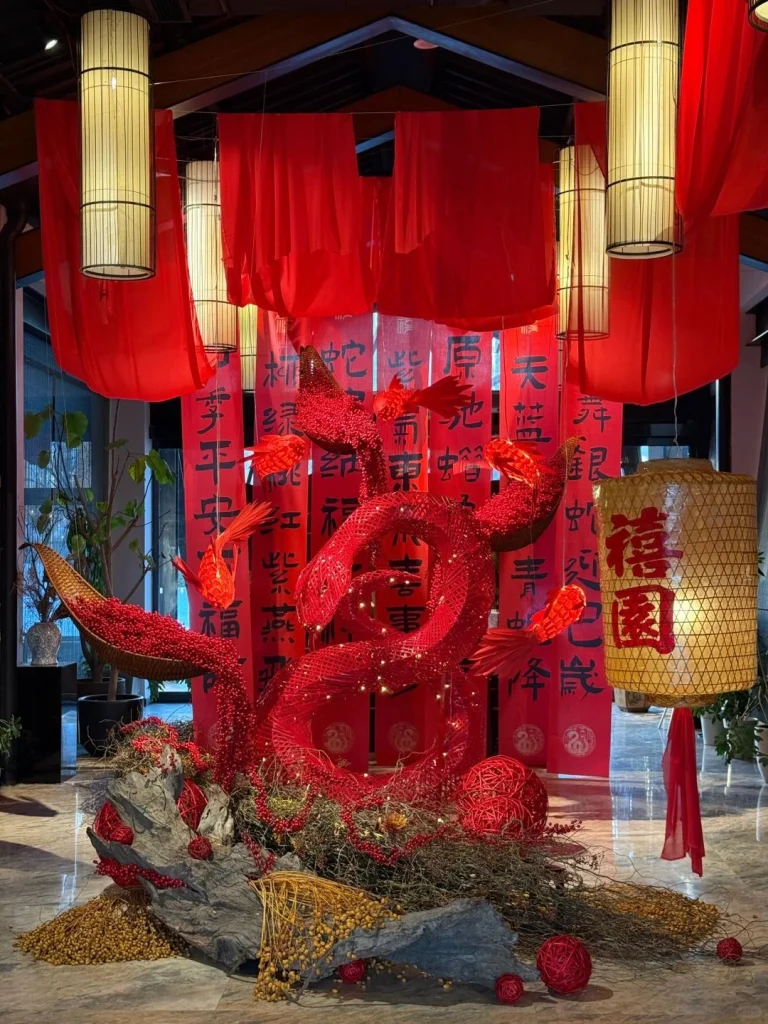 Red serpent themed Chinese New Year decorations with traditional lanterns and calligraphy in Beijing