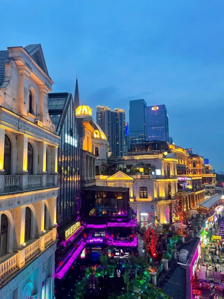 Changsha Nightlife District China Vibrant night scene of a European style street in Changsha illuminated with colorful lights and modern skyscrapers in the background