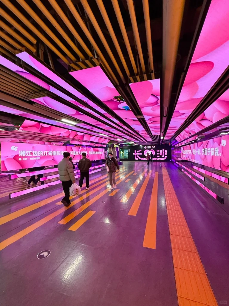 Changsha Underground Light Tunnel A futuristic underground passage in Changsha glowing with vibrant pink lights and modern digital displays