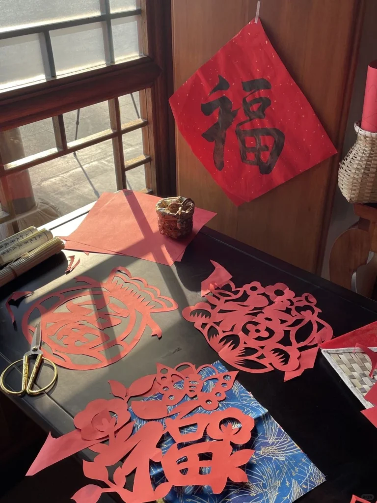 Chinese New Year Paper Cutting Traditional red paper cuttings featuring auspicious symbols for the Lunar New Year displayed on a festive desk - Chinese Holidays and Festivals in 2026: Dates, Traditions & Travel Guide - The China Journey Chinese New Year Paper Cutting Traditional red paper cuttings featuring auspicious symbols for the Lunar New Year displayed on a festive desk - Chinese Holidays and Festivals in 2026: Dates, Traditions & Travel Guide - The China Journey