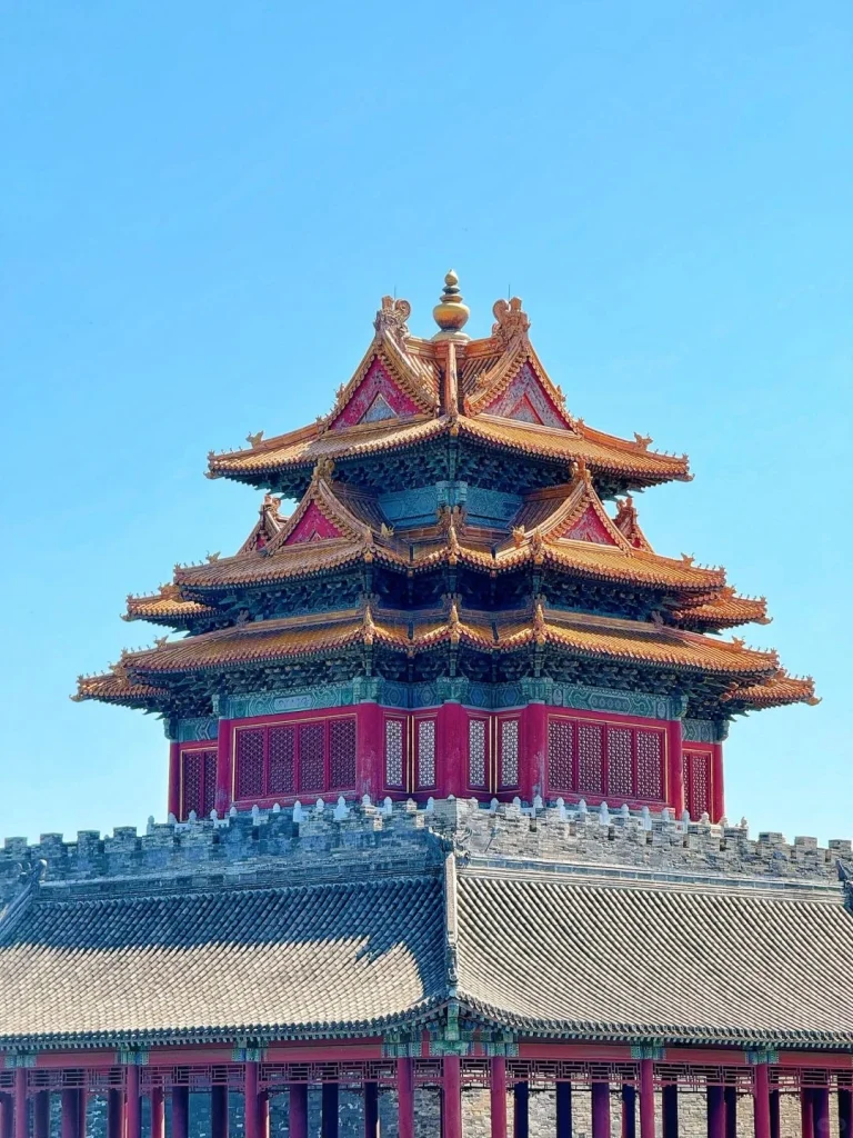 Corner Tower of the Forbidden City Beijing A beautifully preserved corner tower of the Forbidden City in Beijing showcasing intricate Chinese architecture against a bright blue sky