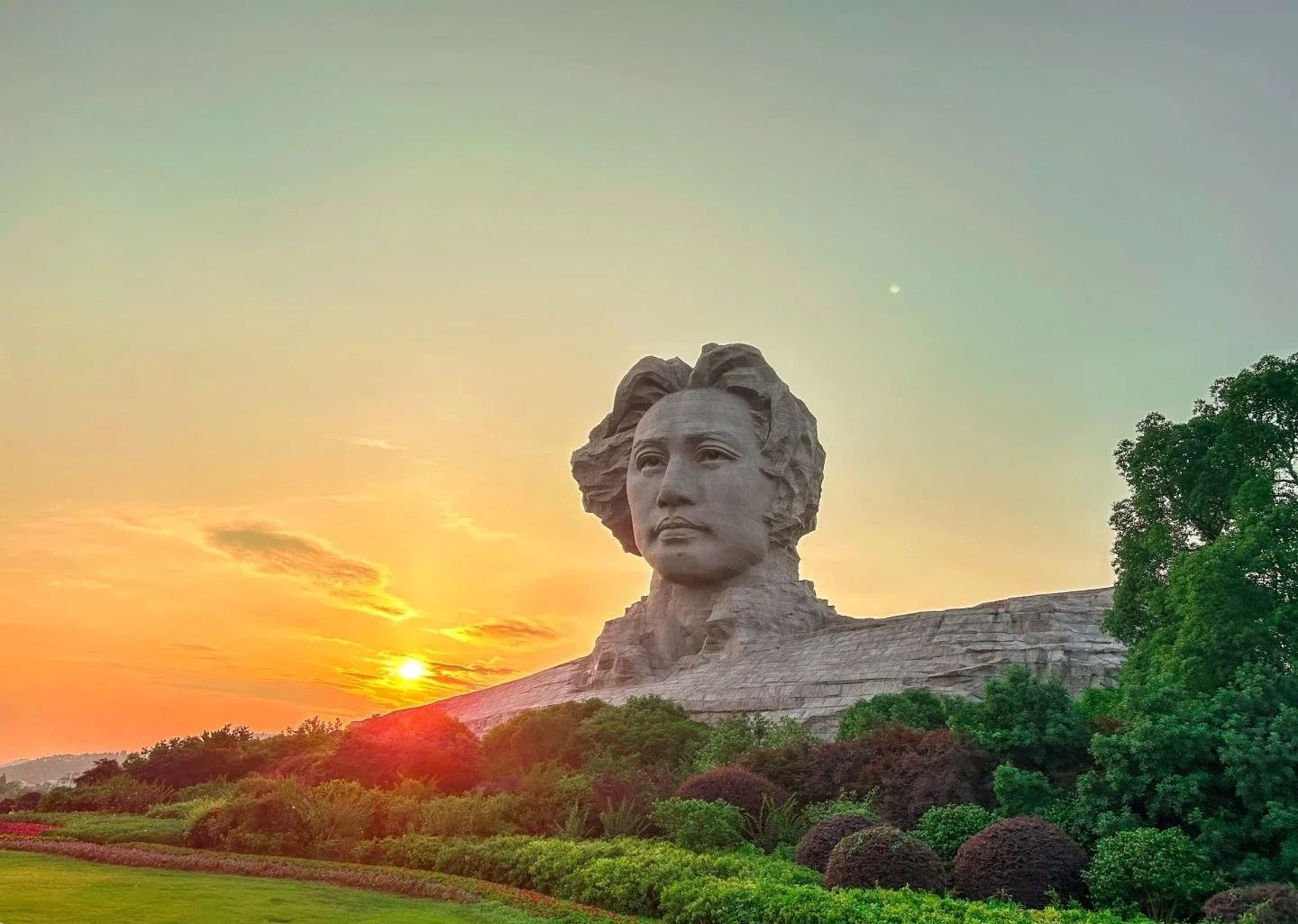 Sunset view of the Young Mao Zedong statue on Orange Isle Changsha surrounded by lush greenery and the Xiang River - Where to Stay in Changsha: Best Areas & Hotels 2026 - The China Journey Sunset view of the Young Mao Zedong statue on Orange Isle Changsha surrounded by lush greenery and the Xiang River - Where to Stay in Changsha: Best Areas & Hotels 2026 - The China Journey