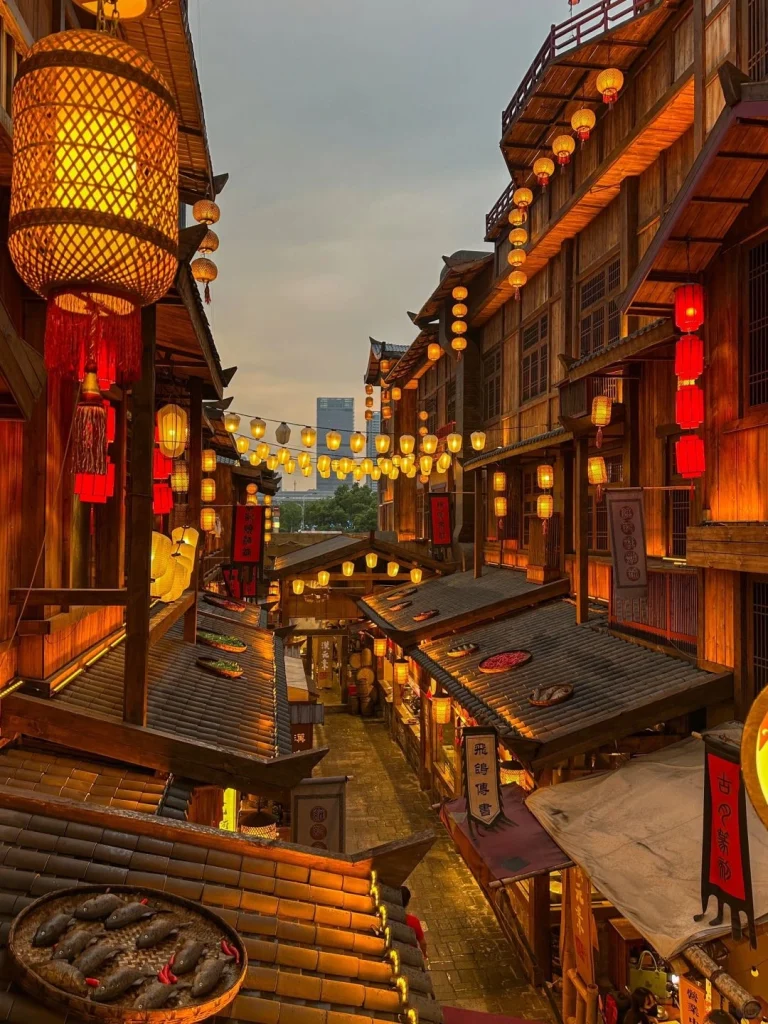 Traditional Chinese alley in Changsha adorned with red lanterns and wooden buildings at dusk
