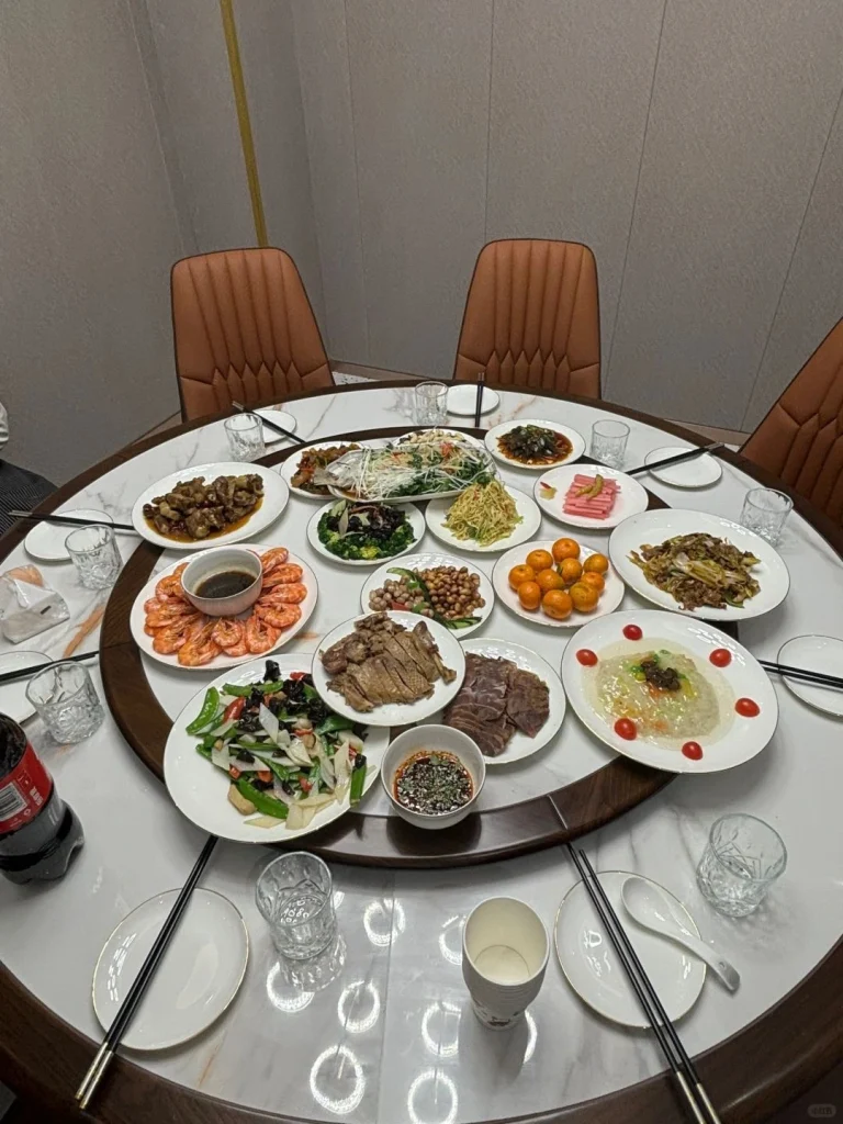 A feast at Laosunjia Restaurant featuring a variety of dishes including shrimp beef and vegetables