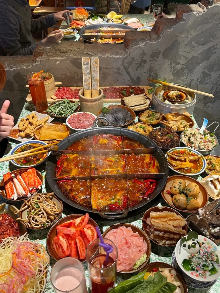 A flavorful Sichuan hotpot surrounded by fresh ingredients spicy broth and vibrant vegetables