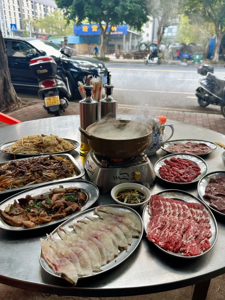 A rich and flavorful congee hotpot with an assortment of meats vegetables and mushrooms