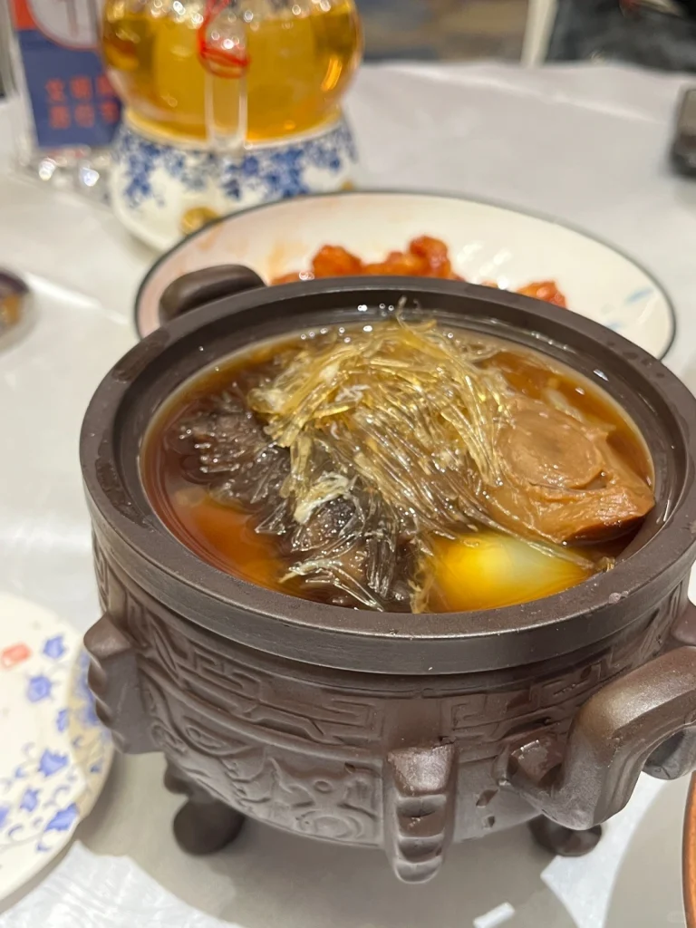 A traditional dish at Fuzhous Juchun Garden A bowl of traditional soup with various ingredients served at Juchun Garden in Fuzhou with a close up of the dish and tea in the background
