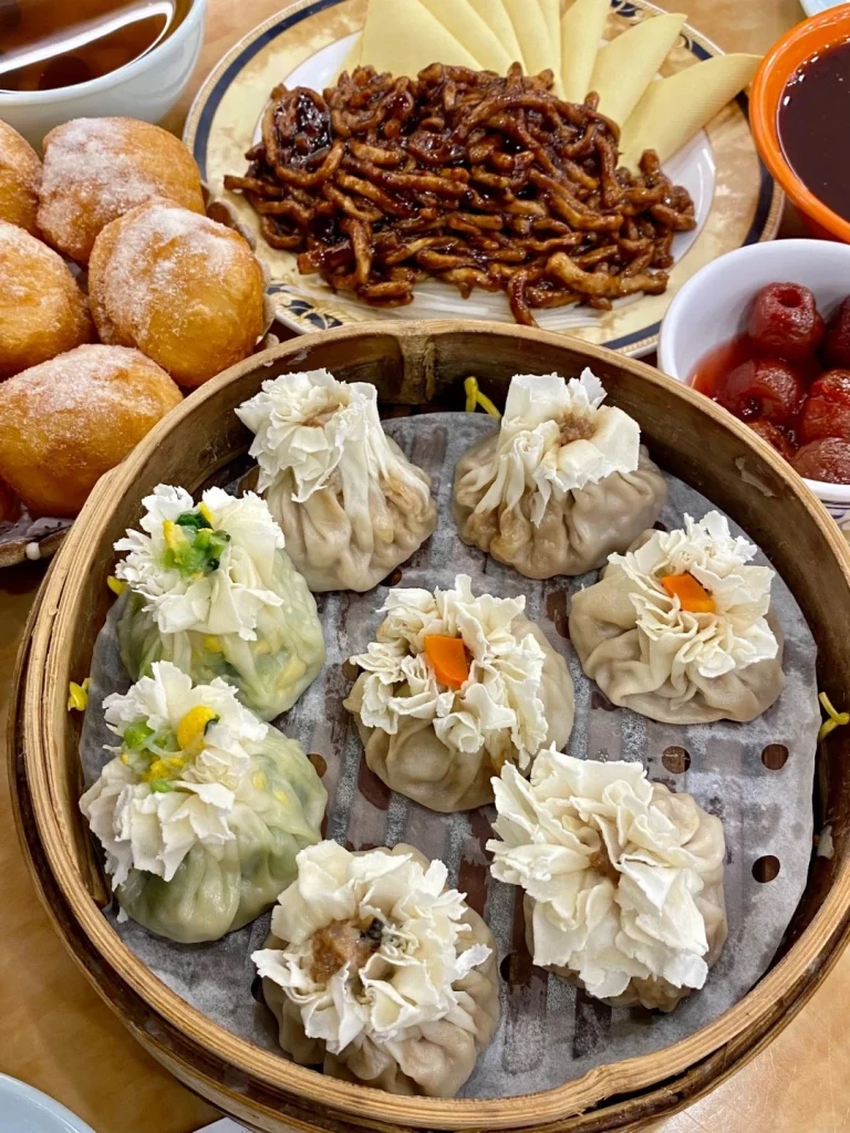 A variety of traditional dishes at Du Yi Chu restaurant in Beijing including sugar coated snacks stir fried pork and unique dumplings