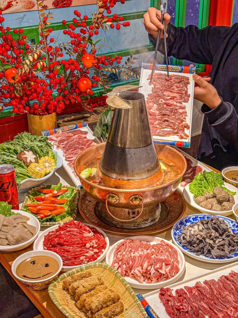 Beijing Copper Pot Hot Pot Copper pot hot pot experience with tender meats vegetables and dipping sauces in a cozy Beijing restaurant