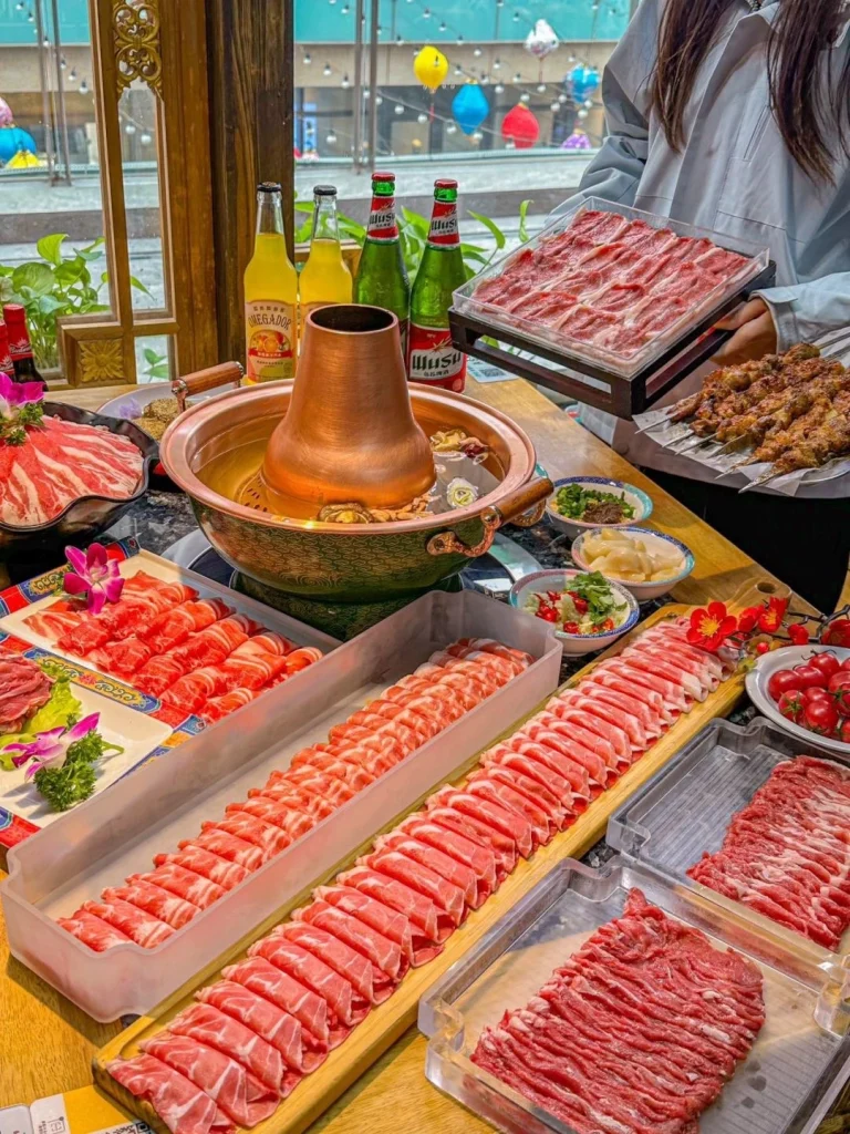 Beijing Copper Pot Hot Pot Traditional copper pot hot pot with sliced meat and vegetables served with sauces in a cozy Beijing restaurant