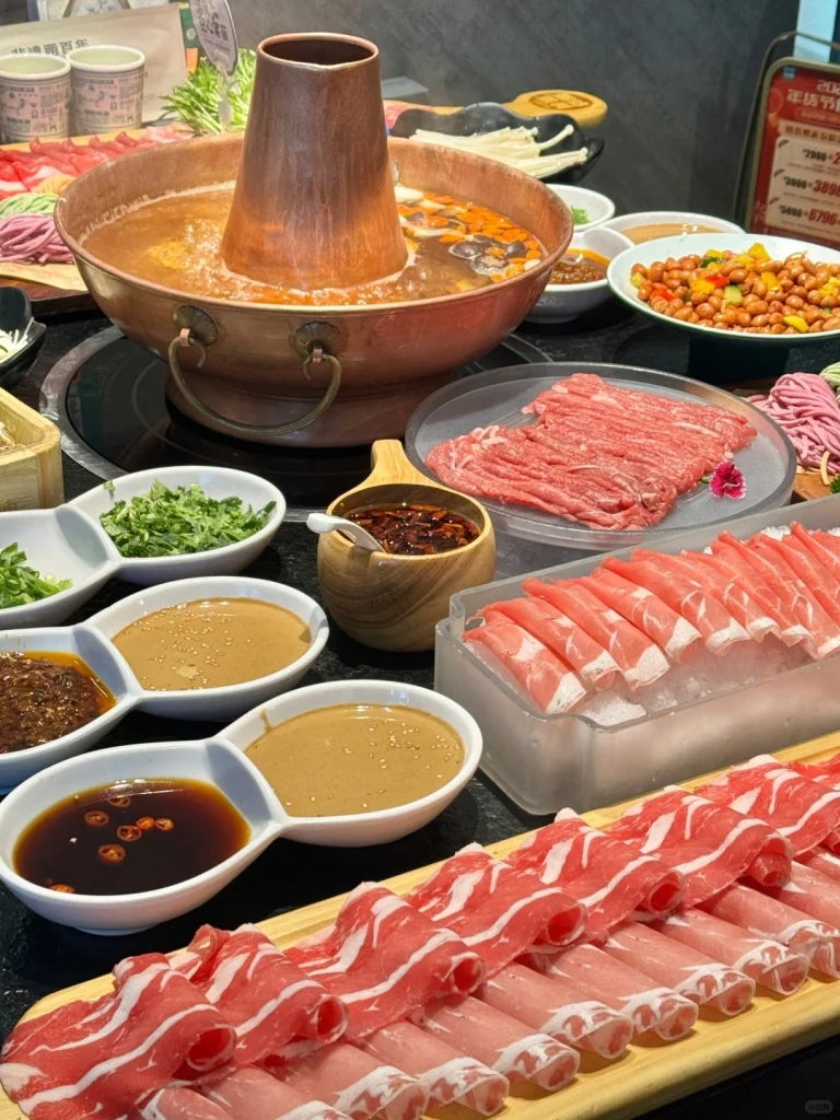 Beijing Copper Pot Hot Pot Warm copper pot hot pot with a variety of meats and fresh vegetables served with dipping sauces