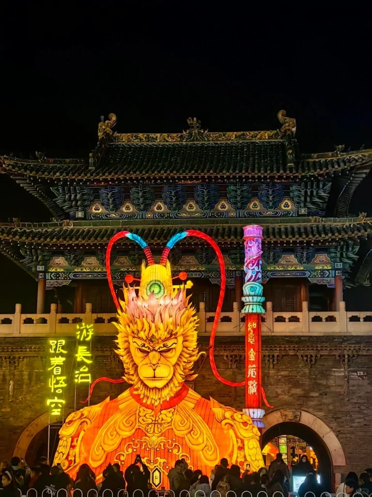 Busy street in Datong Shanxi with vibrant shops and a digital display showing the citys name in large characters
