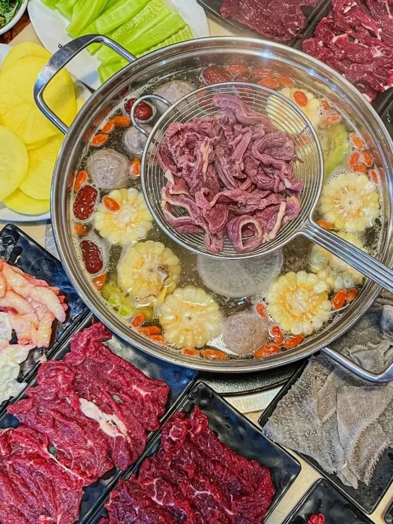 Chaozhou Hotpot Indulgence Beef slices and meatballs cooked in a flavorful broth with fresh vegetables and spices