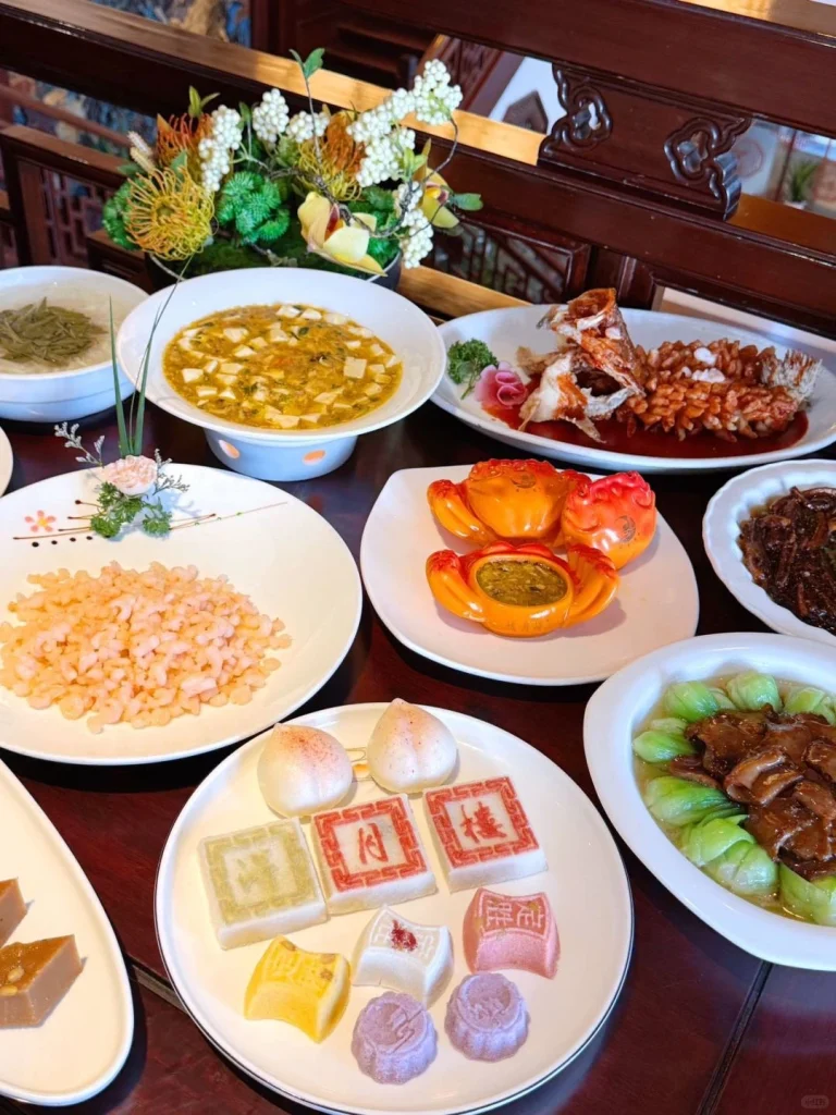 Delicious spread of Suzhou cuisine at Deyue Lou restaurant A variety of dishes including dumplings soup and fish served on white plates