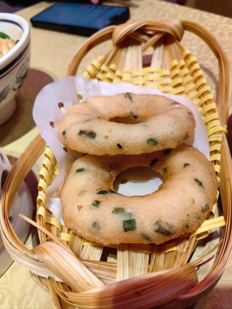 Freshly baked savory pastries served at Fire Palace Changsha accompanied by a warm broth