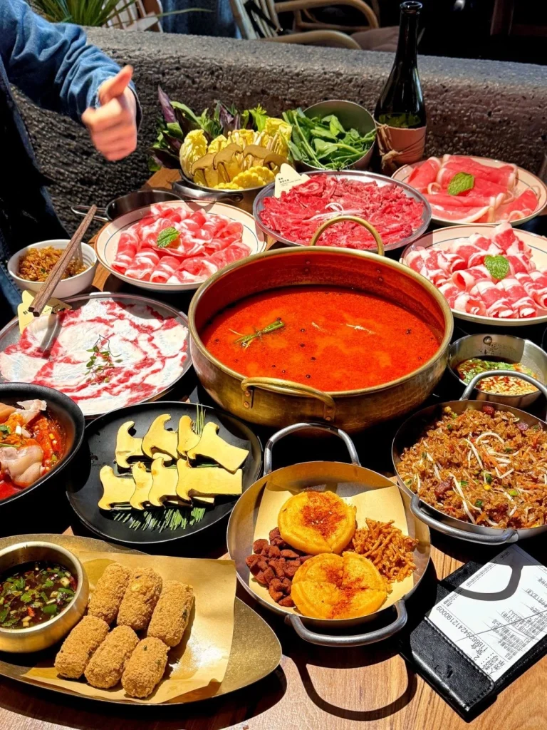 Guizhou Sour Soup Hot Pot A variety of ingredients around a vibrant red sour soup