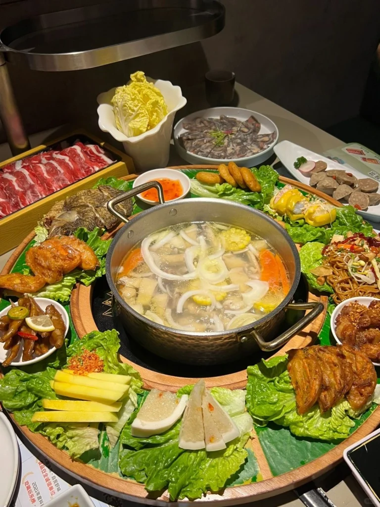 Hainan Coconut Chicken Hot Pot Feast A variety of foods around the simmering pot