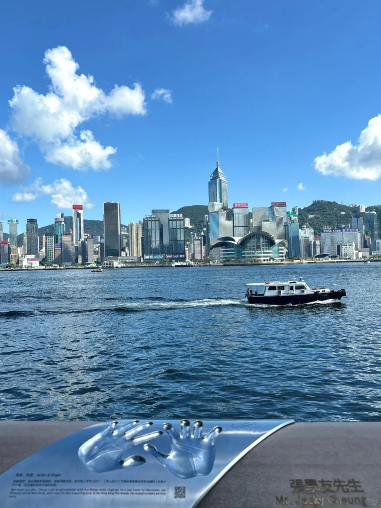 Hong Kongs waterfront view Scenic view of Hong Kongs waterfront with the skyline boats and clear blue skies