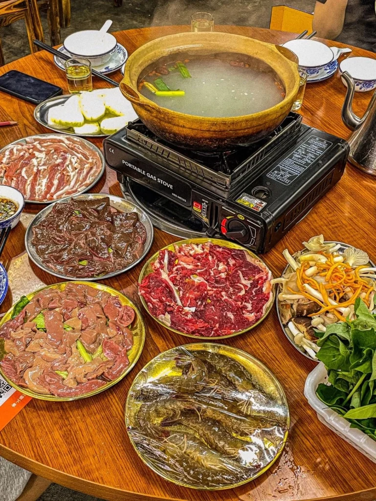 Hotpot filled with fresh seafood vegetables and meats served in a communal dining style in Guangdong