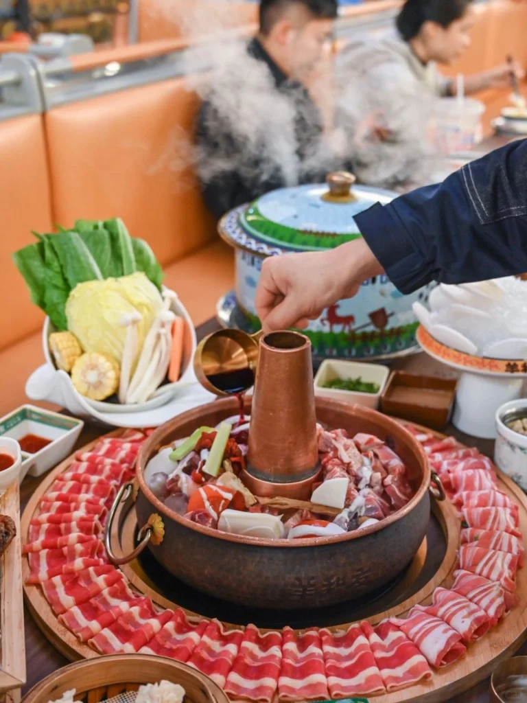 Inner Mongolian Hot Pot Feast Sliced mutton and dumplings ready for boiling