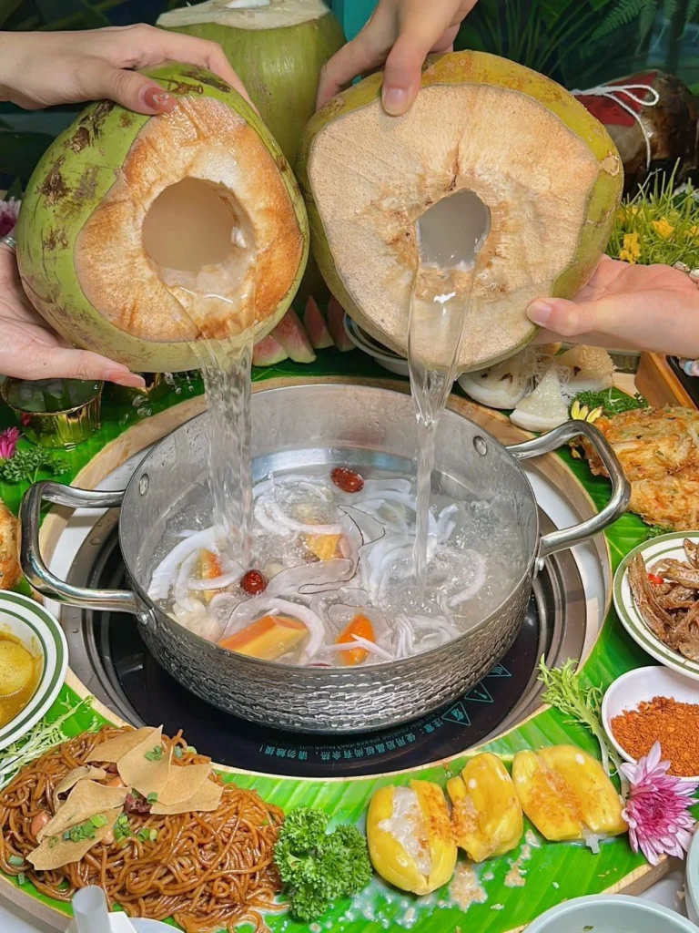 Making the Hot Pot Two hands pouring coconut water into the hot pot