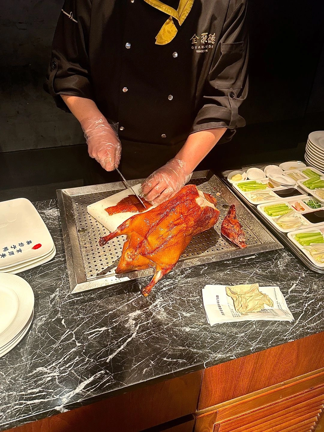 Peking Duck served in style A beautifully arranged plate of Quan Judes signature Peking Duck enjoyed by customers in the iconic restaurant