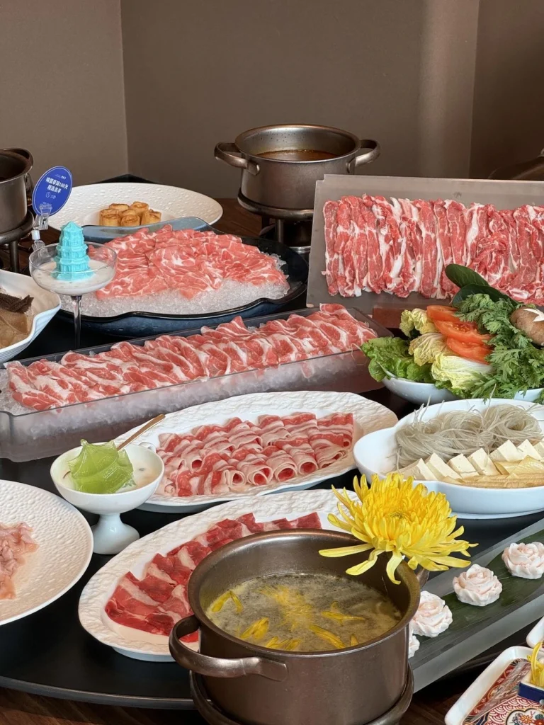 Setup of Jiangsu Zhejiang Chrysanthemum Hot Pot with various meats around
