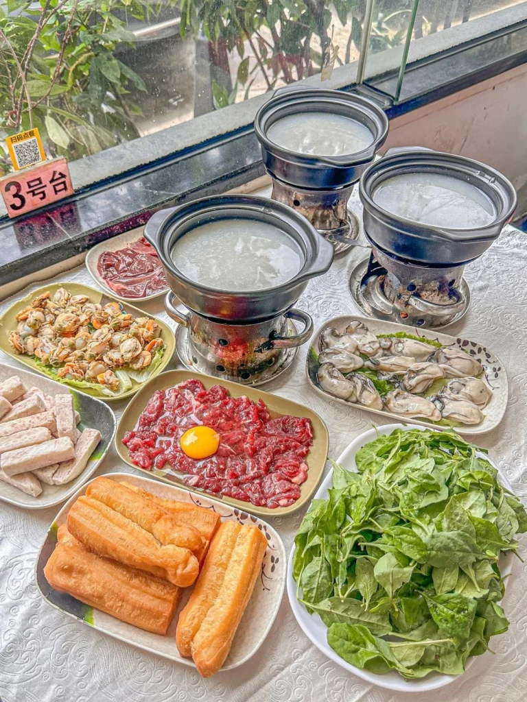 Shunde hotpot with congee base served with various fresh ingredients and condiments