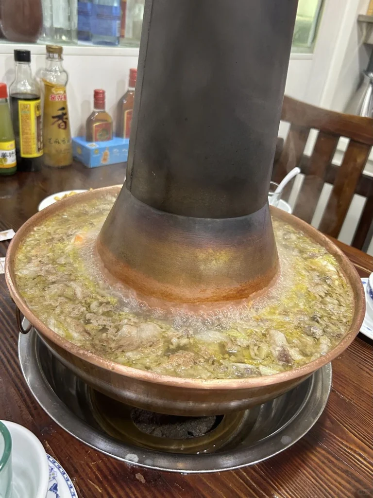Steaming Northeast Hot Pot The copper pot filled with ingredients and broth