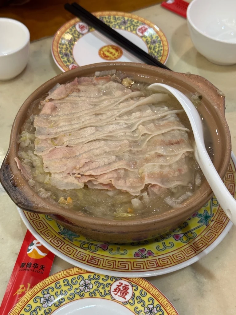 Tender meat in a hot pot at Shaguoju A cozy meal featuring a simmering hot pot with thinly sliced meat at Shaguoju restaurant in Beijing