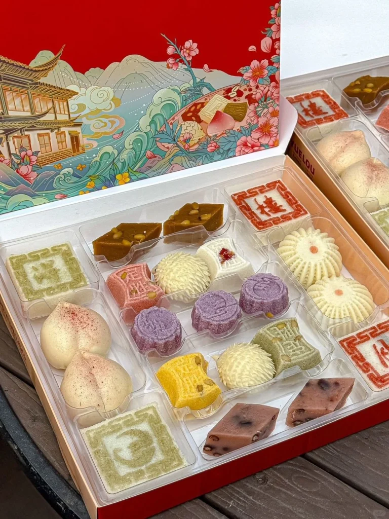 Traditional Chinese sweets in a box from Deyue Lou Assorted colorful pastries and sweets in an elegant packaging with traditional designs