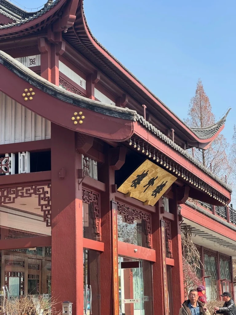 Traditional building entrance of Lou Wai Lou restaurant in Hangzhou showcasing the signature golden sign