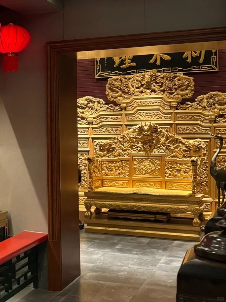 Traditional wooden seating in a Dog Bites Bun restaurant The detailed wooden carving and red lanterns add cultural charm to the ambiance