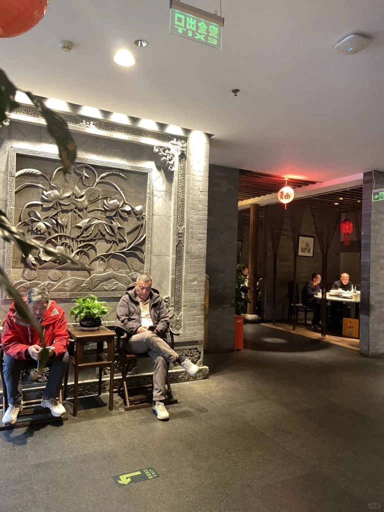 Xian Restaurant hallway A view of the seating area in Xian Restaurant with guests enjoying their meals in a cozy traditional setting