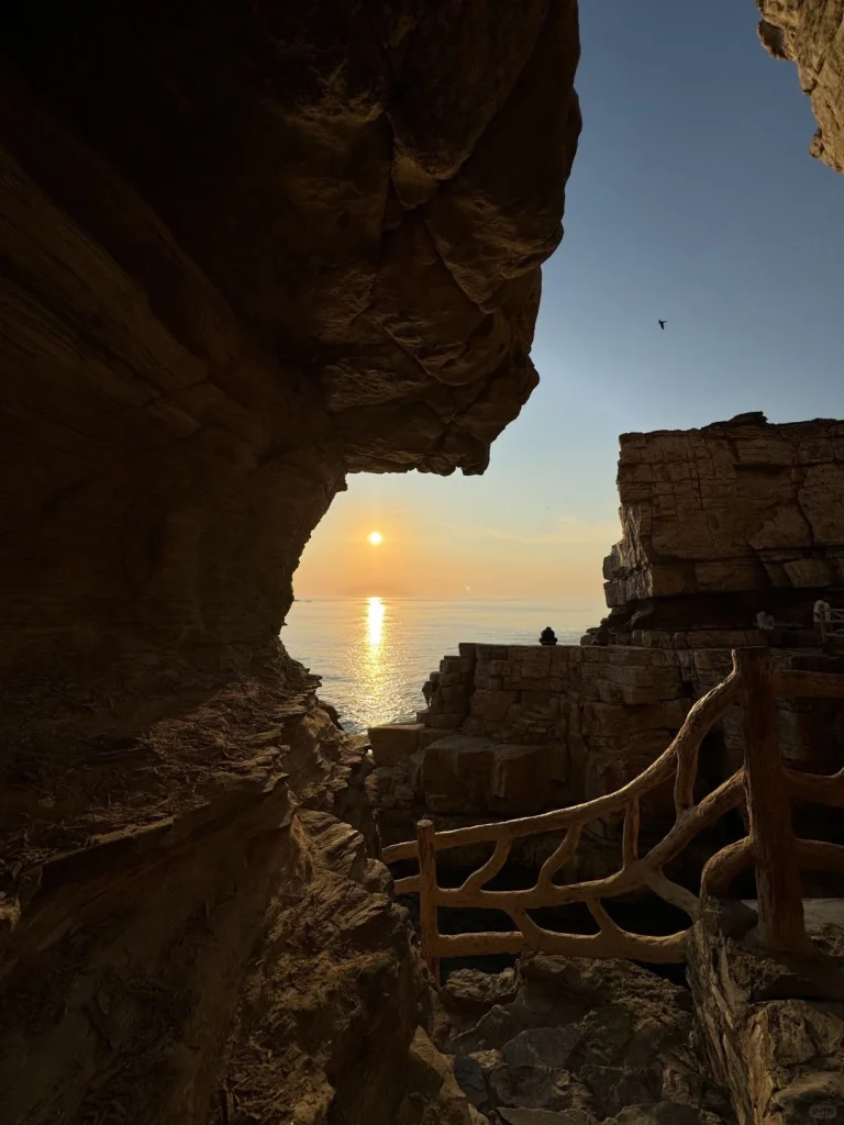Rocky sunset view Dramatic seaside cliffs with sunset light shining through stone formations