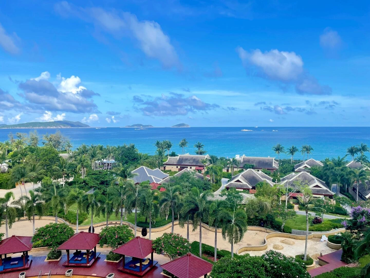 Sanya Yalong Bay Tropical Seaside Resort View – Sunny blue sky over palm trees and ocean at a coastal resort in Sanya, Hainan. - Where to Stay in Sanya: Best Areas & Hotels 2026 - The China Journey Sanya Yalong Bay Tropical Seaside Resort View – Sunny blue sky over palm trees and ocean at a coastal resort in Sanya, Hainan. - Where to Stay in Sanya: Best Areas & Hotels 2026 - The China Journey