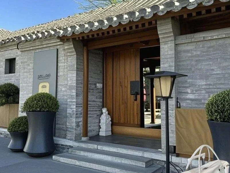 Courtyard house in Beijing with modern entrance Traditional grey brick siheyuan courtyard home in Beijing under a clear blue sky. - How Much Money Do You Need Per Day in Beijing? 2026 - The China Journey Courtyard house in Beijing with modern entrance Traditional grey brick siheyuan courtyard home in Beijing under a clear blue sky. - How Much Money Do You Need Per Day in Beijing? 2026 - The China Journey