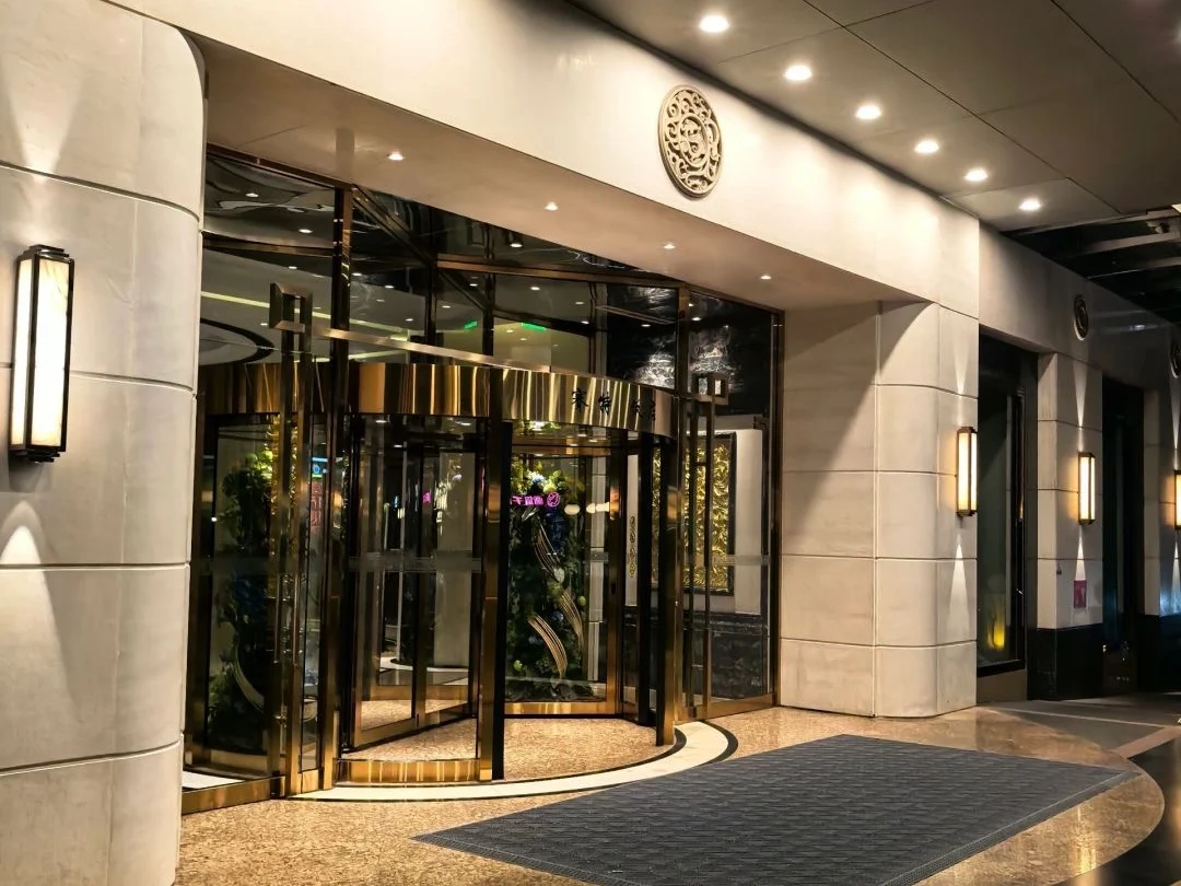 Luxury hotel entrance in Beijing at night Elegant nighttime view of a revolving glass door at a five star hotel in Beijing. - How Much Money Do You Need Per Day in Beijing? 2026 - The China Journey Luxury hotel entrance in Beijing at night Elegant nighttime view of a revolving glass door at a five star hotel in Beijing. - How Much Money Do You Need Per Day in Beijing? 2026 - The China Journey